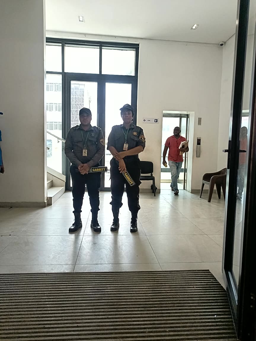 Sarf Guards officers conducting security screening with metal detectors